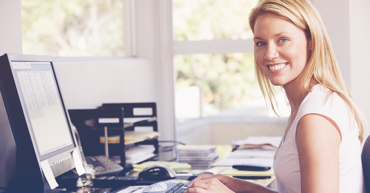 smiling woman at laptop leading remote team
