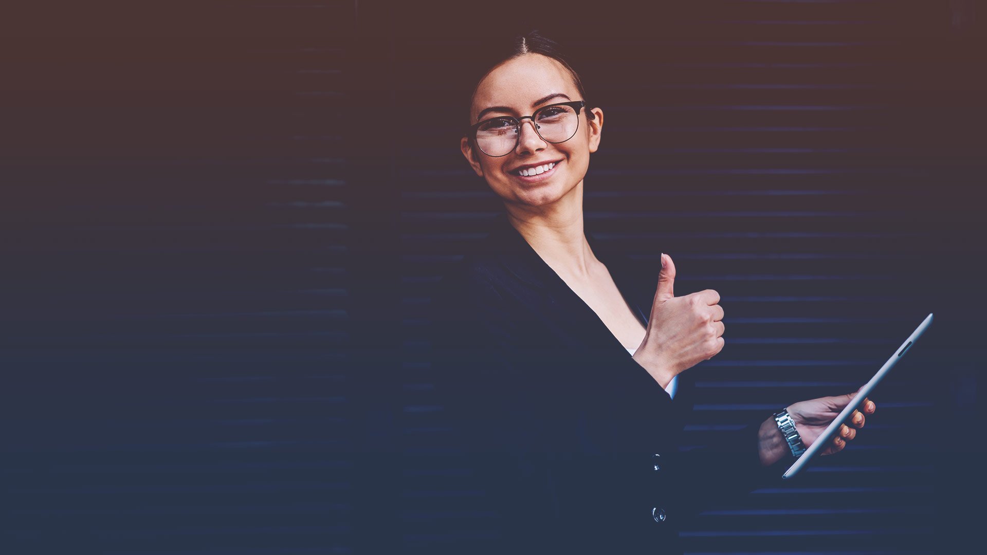 Young professional woman giving a thumbs up signal