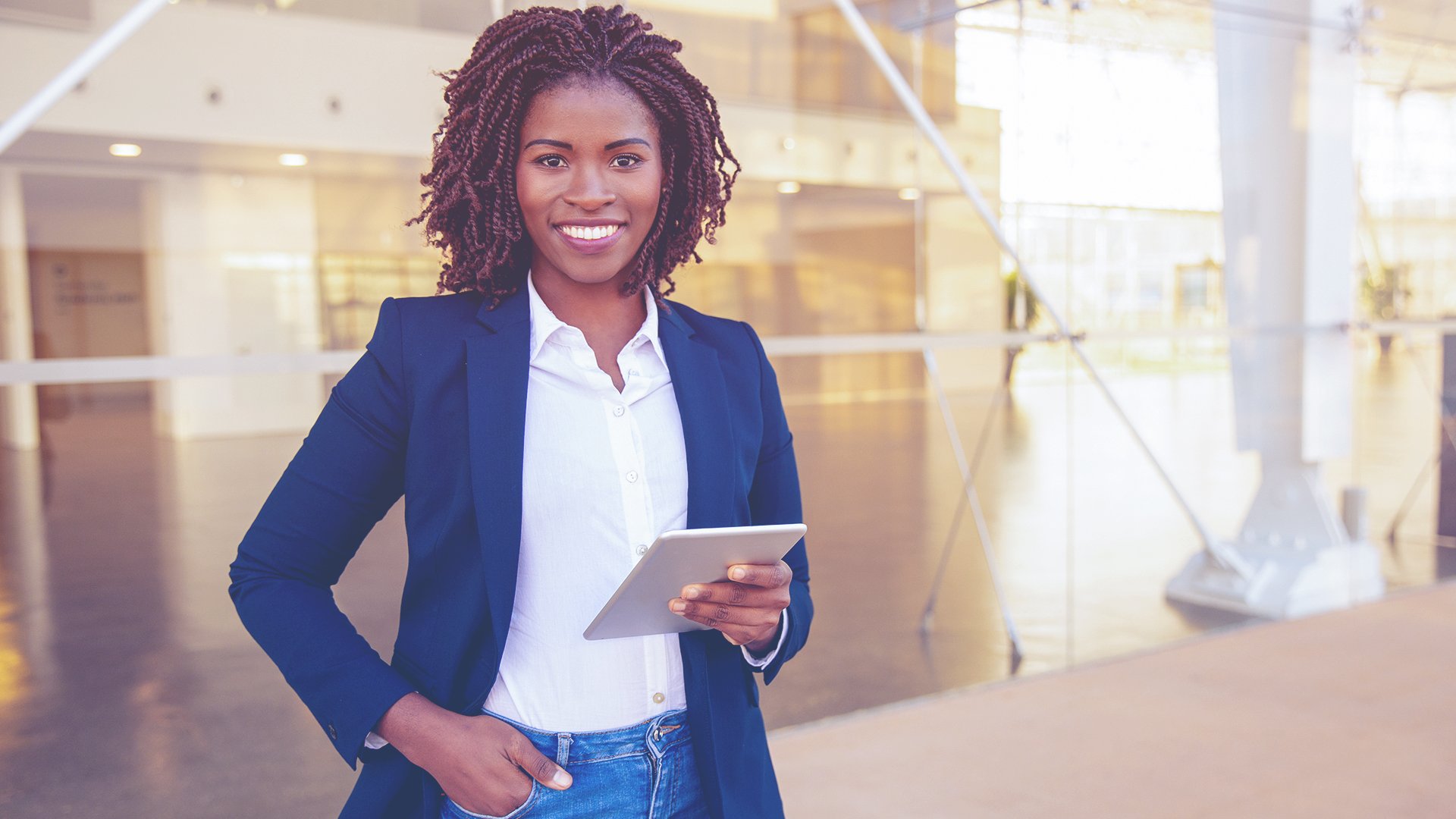 confident African American woman smiling at camera outside of professional workplace
