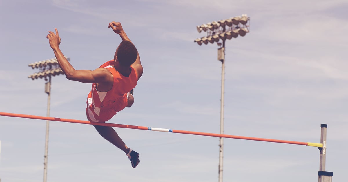man competing in high jump